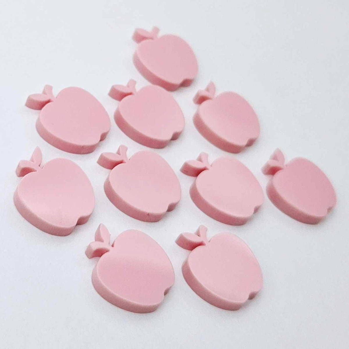 14mm pastel pink acrylic apple earring stud blanks laid flat together.