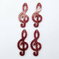 40mm red glitter treble clef earring dangle blanks laid flat together.