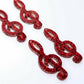 40mm red glitter treble clef earring dangle blanks laid flat together.
