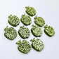 14mm light green glitter acrylic apple earring stud blanks laid flat together.