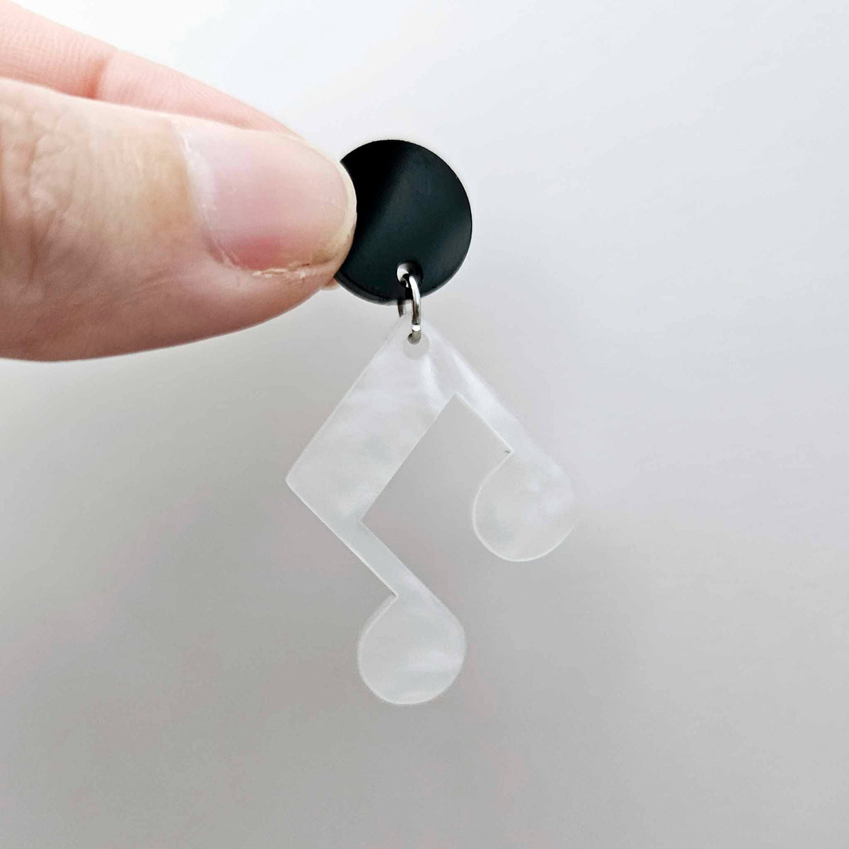 35mm white marble acrylic music note earring dangle blank assembled with a 14mm black topper, showing the lightweight finished earring design.