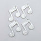 Two pairs of 35mm white marble acrylic music note earring dangle blanks laid flat together.