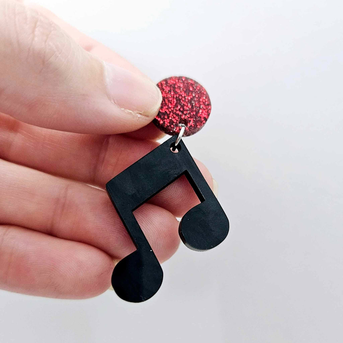 35mm black marble acrylic music note earring dangle blank assembled with a 14mm red glitter topper, showing the lightweight finished earring design.