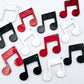 35mm marble music note earring dangle blanks in red, black and white marble acrylic, with two pairs of each colour laid flat together.