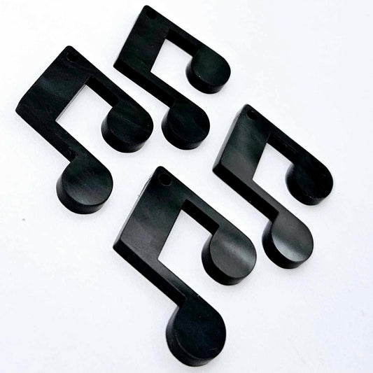 Two pairs of 35mm black marble acrylic music note earring dangle blanks laid flat together.