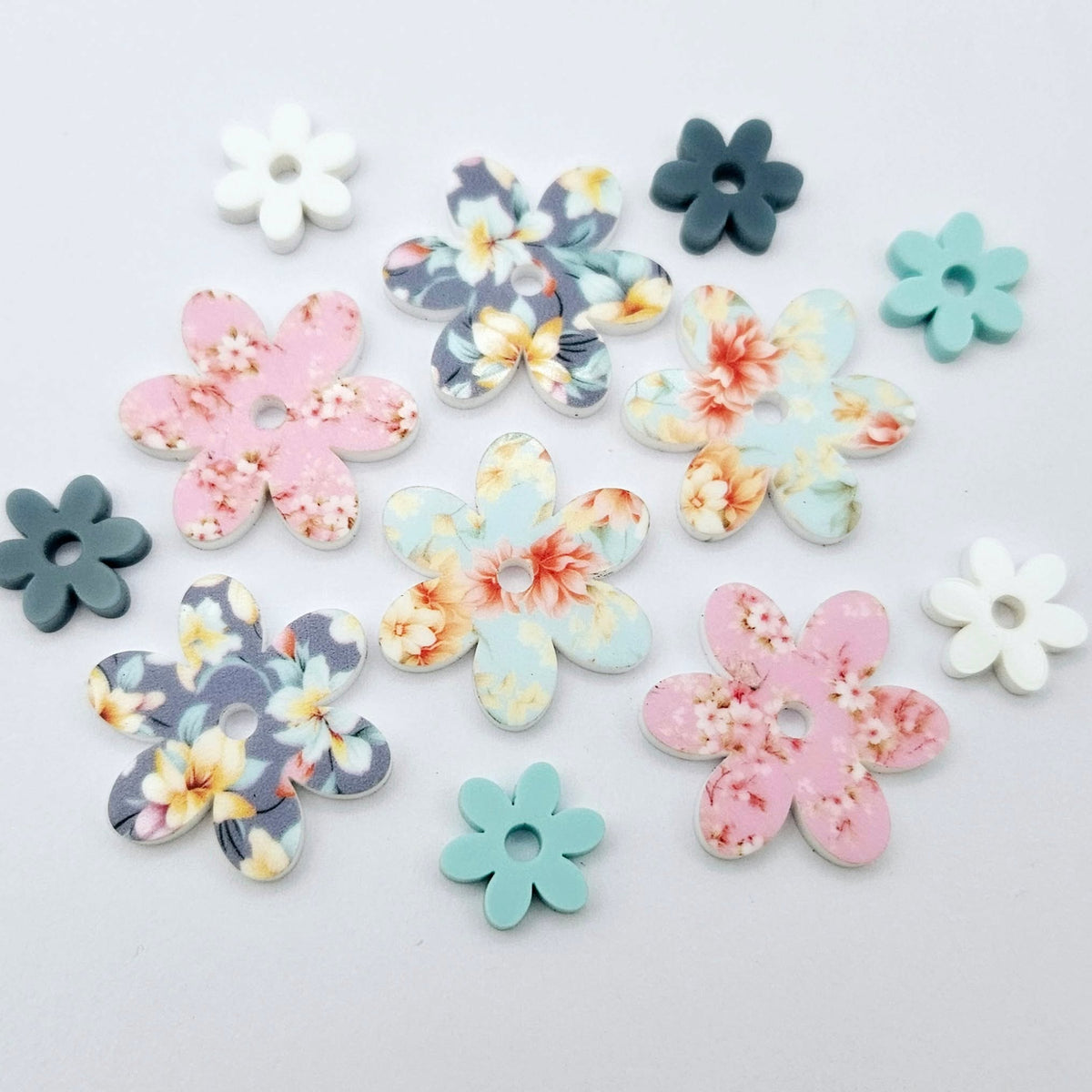 UV printed acrylic flower earring blanks in Cherry Blossom and White, Floral Bloom and Pastel Aqua, and Hawaii Dream and Bluestone, featuring two-piece floral designs made for 20mm hoop earrings.