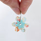 Two-piece Floral Bloom and Pastel Aqua UV printed acrylic flower earring blanks assembled on 20mm stainless steel hoops, showing how the floral pieces combine to create lightweight statement earrings.