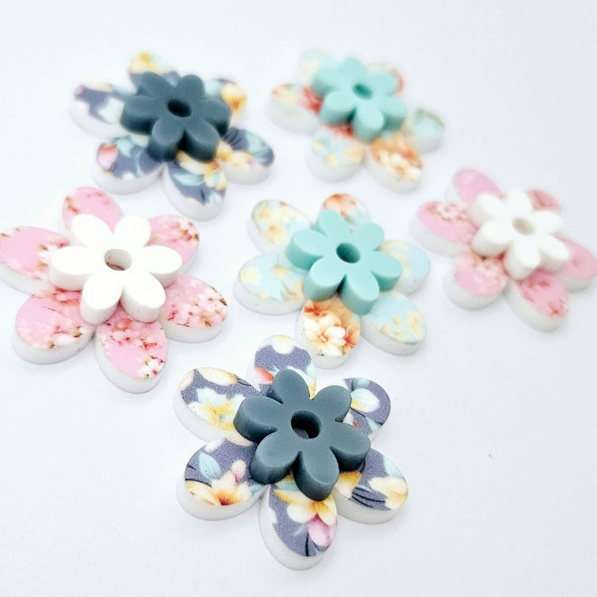 UV printed acrylic flower earring blanks in Cherry Blossom and White, Floral Bloom and Pastel Aqua, and Hawaii Dream and Bluestone, featuring two-piece floral designs made for 20mm hoop earrings.