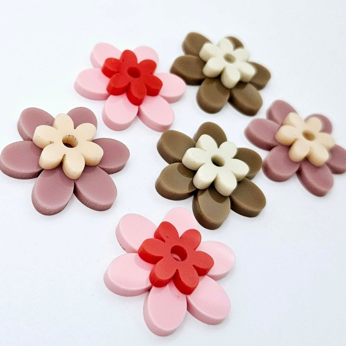 Two-piece solid acrylic flower earring blanks in Pastel Pink and Red, Dusty Rose and Peach, and Iced Coffee and Cream, laid flat together and designed for 20mm hoop earrings.