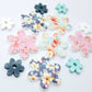 UV printed acrylic flower earring blanks in Cherry Blossom and White, Floral Bloom and Pastel Aqua, and Hawaii Dream and Bluestone, featuring two-piece floral designs made for 20mm hoop earrings.