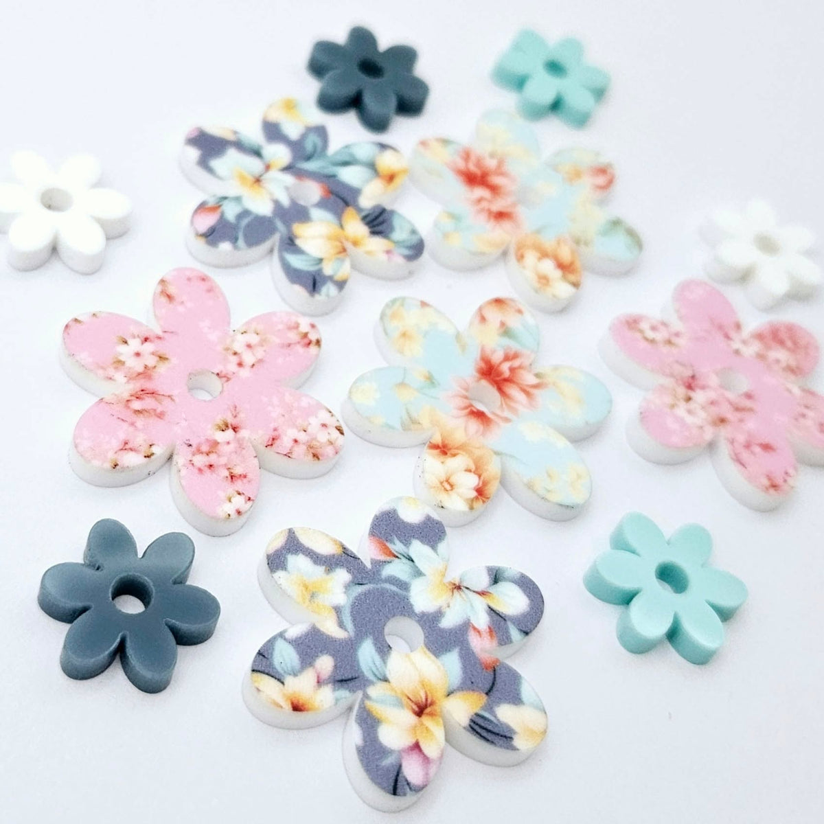 UV printed acrylic flower earring blanks in Cherry Blossom and White, Floral Bloom and Pastel Aqua, and Hawaii Dream and Bluestone, featuring two-piece floral designs made for 20mm hoop earrings.