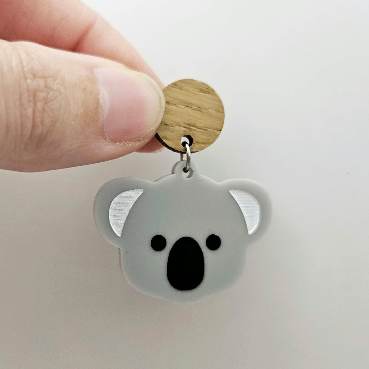 Solid grey acrylic koala dangle earring blank assembled with a 14mm Oak wooden topper, featuring black paint-filled eyes and nose with white inner ears, showing how the pieces can be combined to create a finished koala earring.