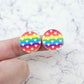 One pair of 20mm Rainbow Love UV printed acrylic stud earring blanks displayed on a finger to show their size, perfect for creating fun statement stud earrings.