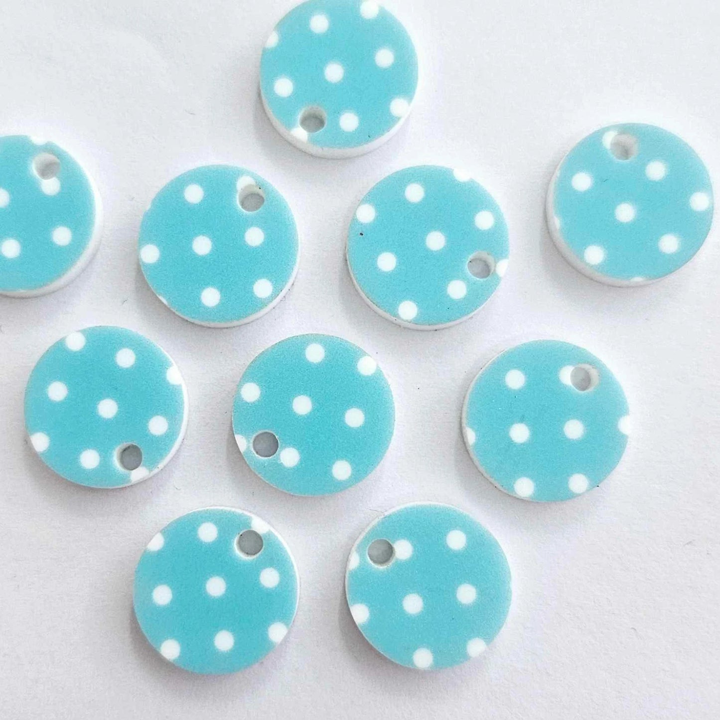 Ten 14mm Pastel Polka Dot UV printed acrylic earring toppers in blue with white polka dots laying flat